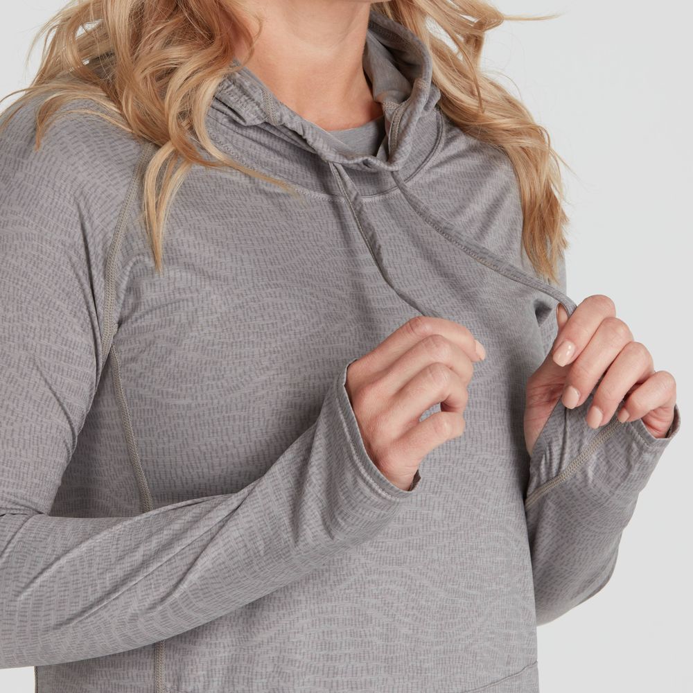 Person wearing a gray long-sleeve Silkweight Hoodie Dress by NRS, featuring a subtle pattern and hood strings. Made from recycled materials, it offers style, comfort, and sun protection for outdoor adventures.