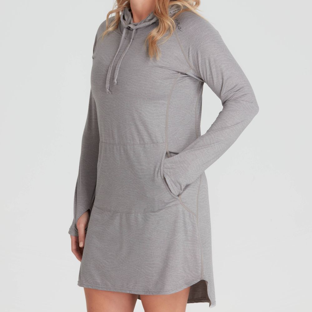 Against a plain background, an individual showcases the gray NRS Silkweight Hoodie Dress featuring thumbholes and pockets. Made from recycled materials, this stylish dress provides sun protection for bright days.