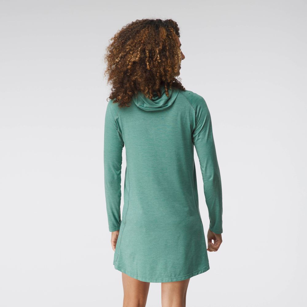A person with curly hair wears an NRS Silkweight Hoodie Dress made from recycled material in green, standing with their back to the camera against a plain white background.