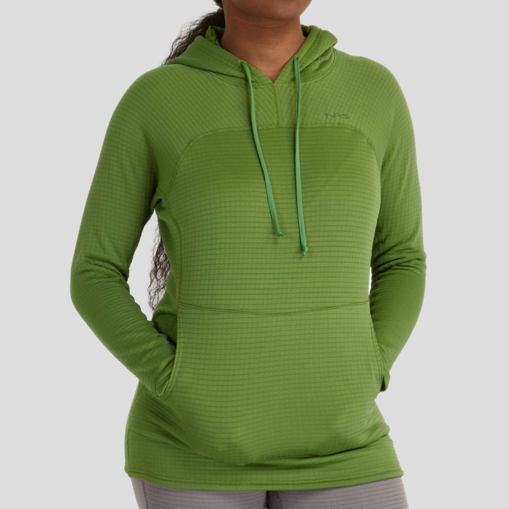 A woman in an NRS Lightweight Hoodie, featuring green moisture-wicking fabric, stands with her hands in the front pocket against a plain background.