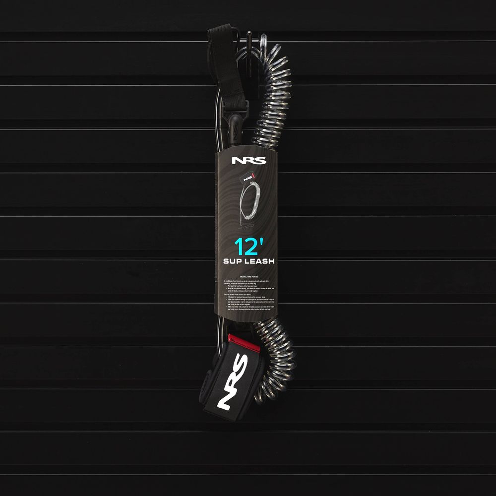 The NRS Coil SUP Leash, a 12-foot coiled leash ideal for stand-up paddling, is elegantly showcased in its packaging against a sleek black background.