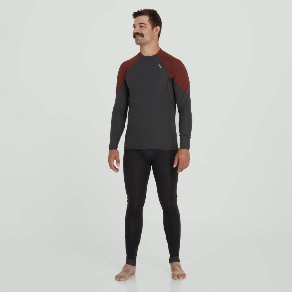 A man stands barefoot against a plain white background, wearing NRS Hydroskin 0.5mm Pants for men, a gray and maroon long-sleeved athletic outfit featuring neoprene padding for added warmth and comfort.