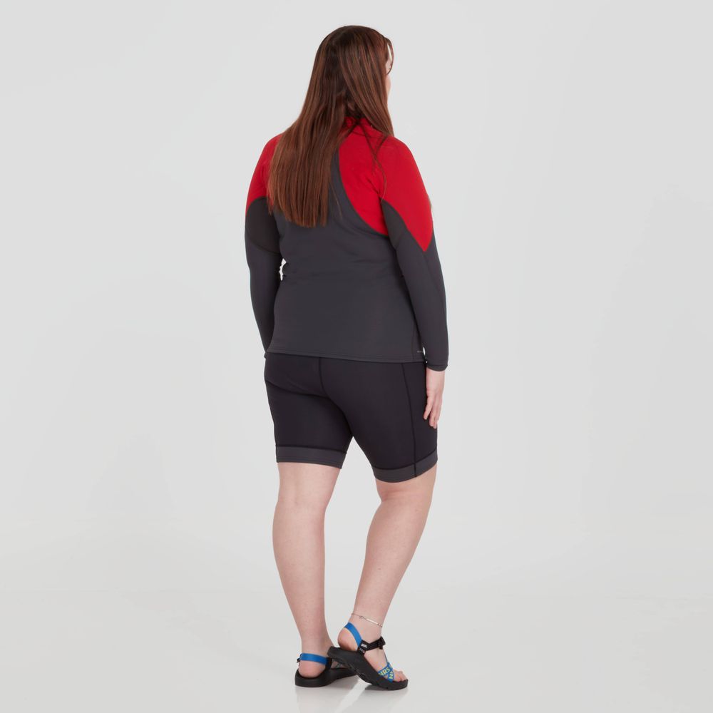 The person is wearing a gray and red wetsuit paired with NRS HydroSkin 0.5mm Shorts for women, designed to boost paddling performance, against a white background, facing away.