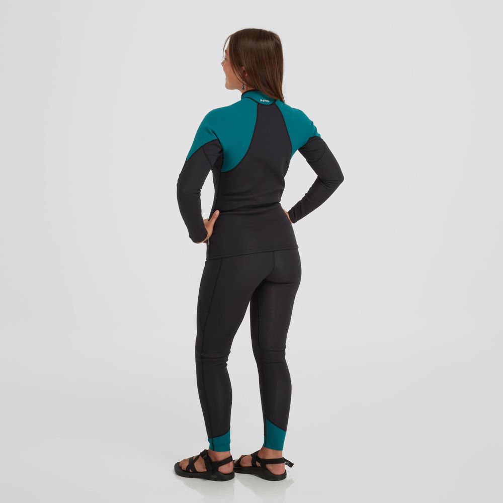 A person wearing the NRS Hydroskin 1.5mm Jacket in black and teal, designed with neoprene insulation for enhanced paddling performance, stands with hands on hips against a white background.