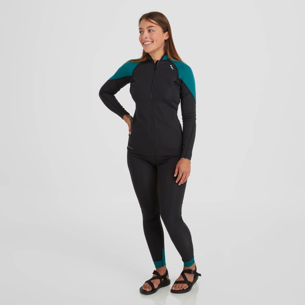 A person models the NRS Hydroskin 1.5mm Jacket - Women's, a black and teal wetsuit designed with neoprene for optimal paddling performance, standing against a plain white background and wearing sandals.