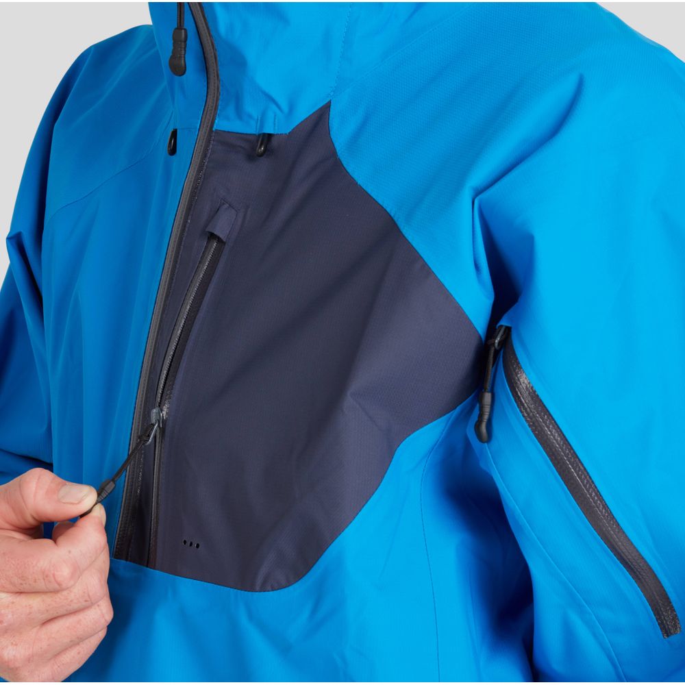A person gingerly adjusts the zipper on the NRS High Tide Jacket - Men's, ensuring optimal paddling protection. The blue and black design features an adjustable hood, providing both style and functionality in harsh weather conditions.