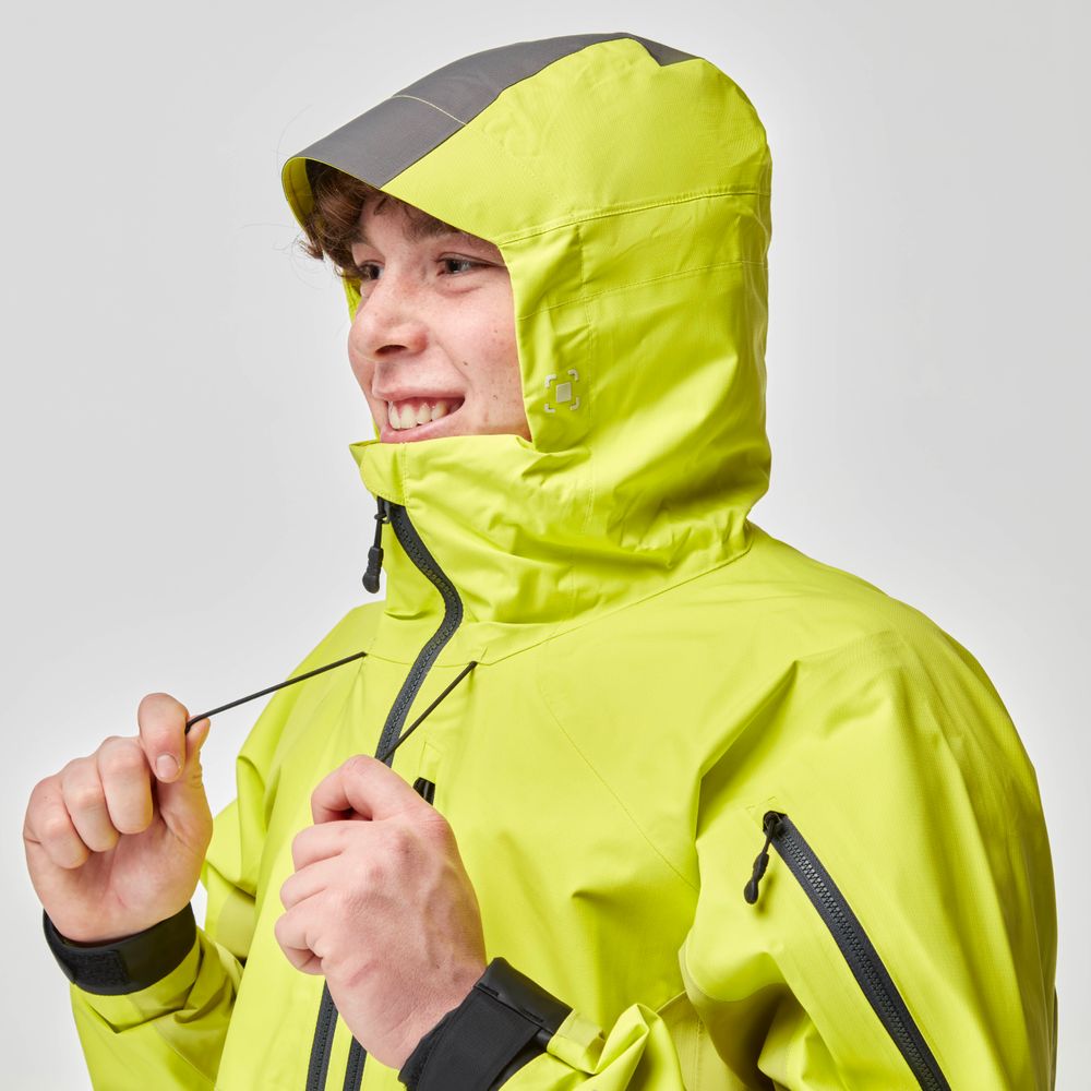 A person wearing the NRS High Tide Jacket for men in a vibrant yellow, cinching the hood's drawstrings tightly.