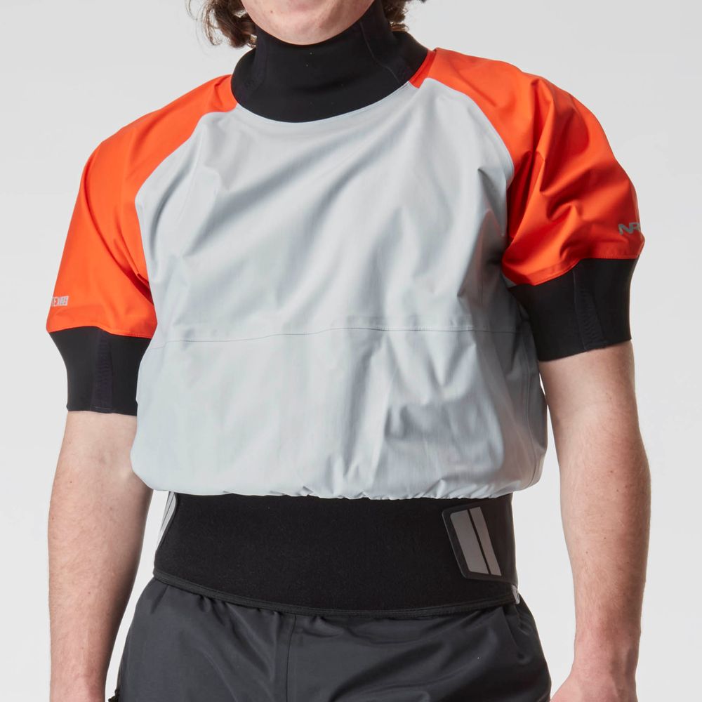 Someone wearing the NRS Stratos Short Sleeve Paddling Jacket, featuring a gray and orange design with black detailing, is protected by waterproof fabric and neoprene seals to stay dry while kayaking.