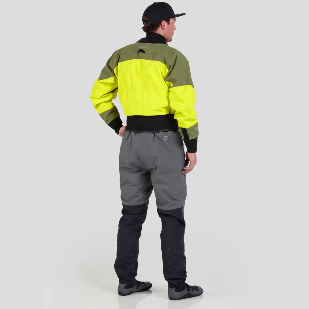 A person in a vibrant NRS REV (GORE-TEX Pro) Drytop, gray pants, black cap, and shoes stands with their back to the camera against a plain background.