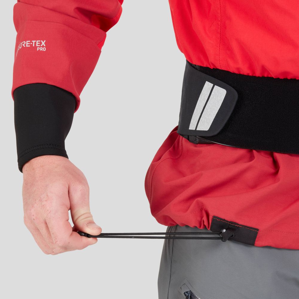 Adjusting the drawstring on an NRS REV (GORE-TEX Pro) Drytop, this person is set for top paddling performance, pairing the vibrant red outerwear with gray pants.