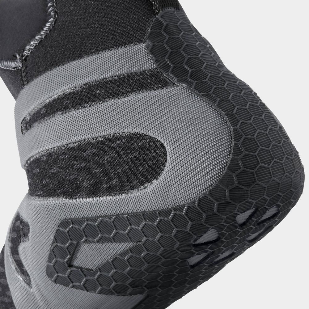 Close-up of the NRS Freestyle WetShoe, highlighting its black and gray design with textured minimalist rubber soles and a fabric upper featuring a geometric pattern.