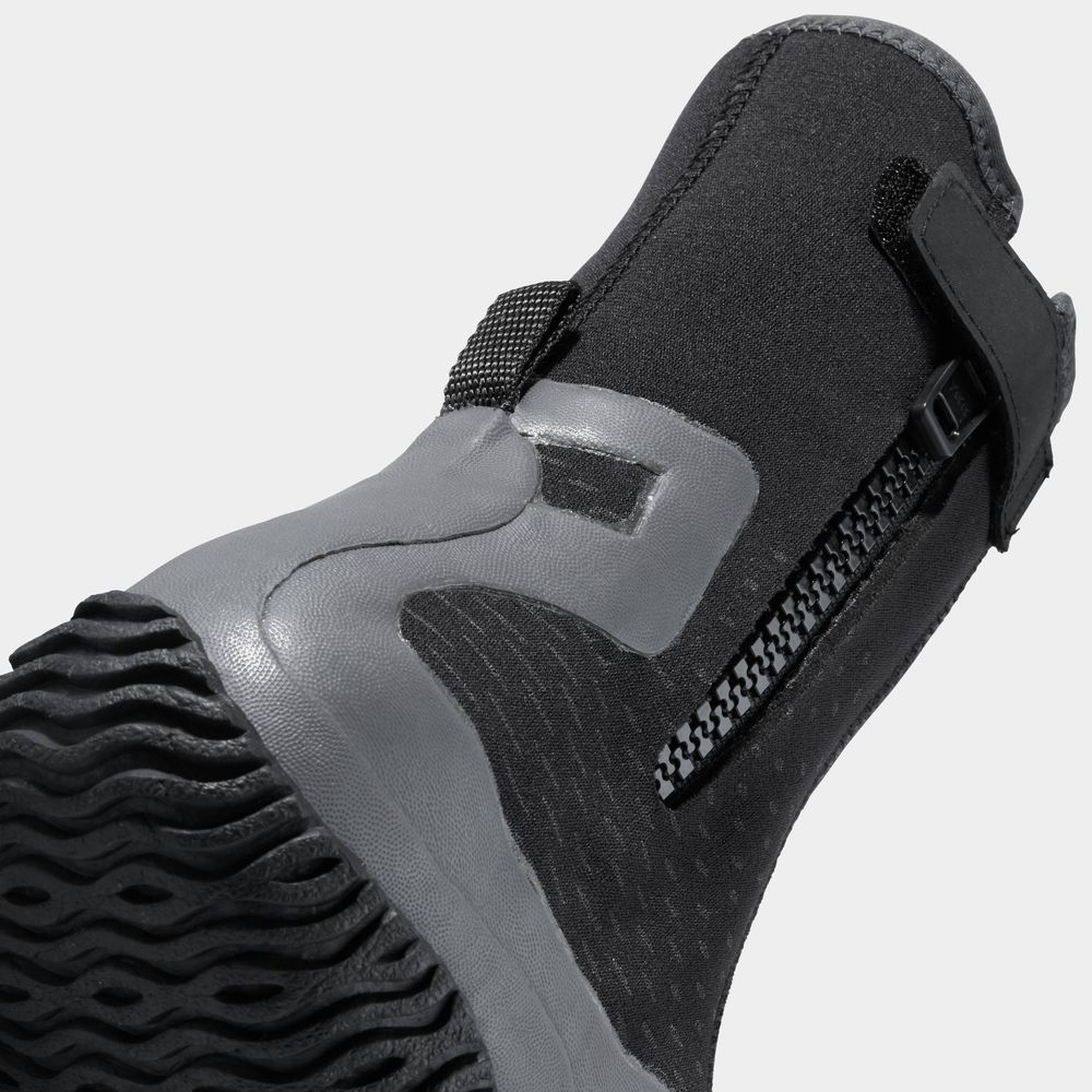 Close-up of the NRS Paddle WetShoe boot in black and gray, showcasing its high-traction sole, side zipper, and neoprene strap for a secure fit.