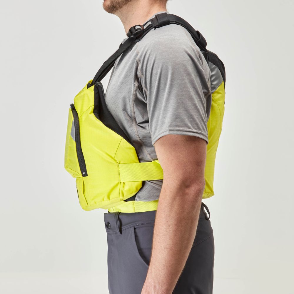 A person in a gray t-shirt and dark pants is shown in profile, modeling the NRS Ninja PFD, a bright yellow performance flotation jacket for paddlers with adjustable straps for a compact fit.