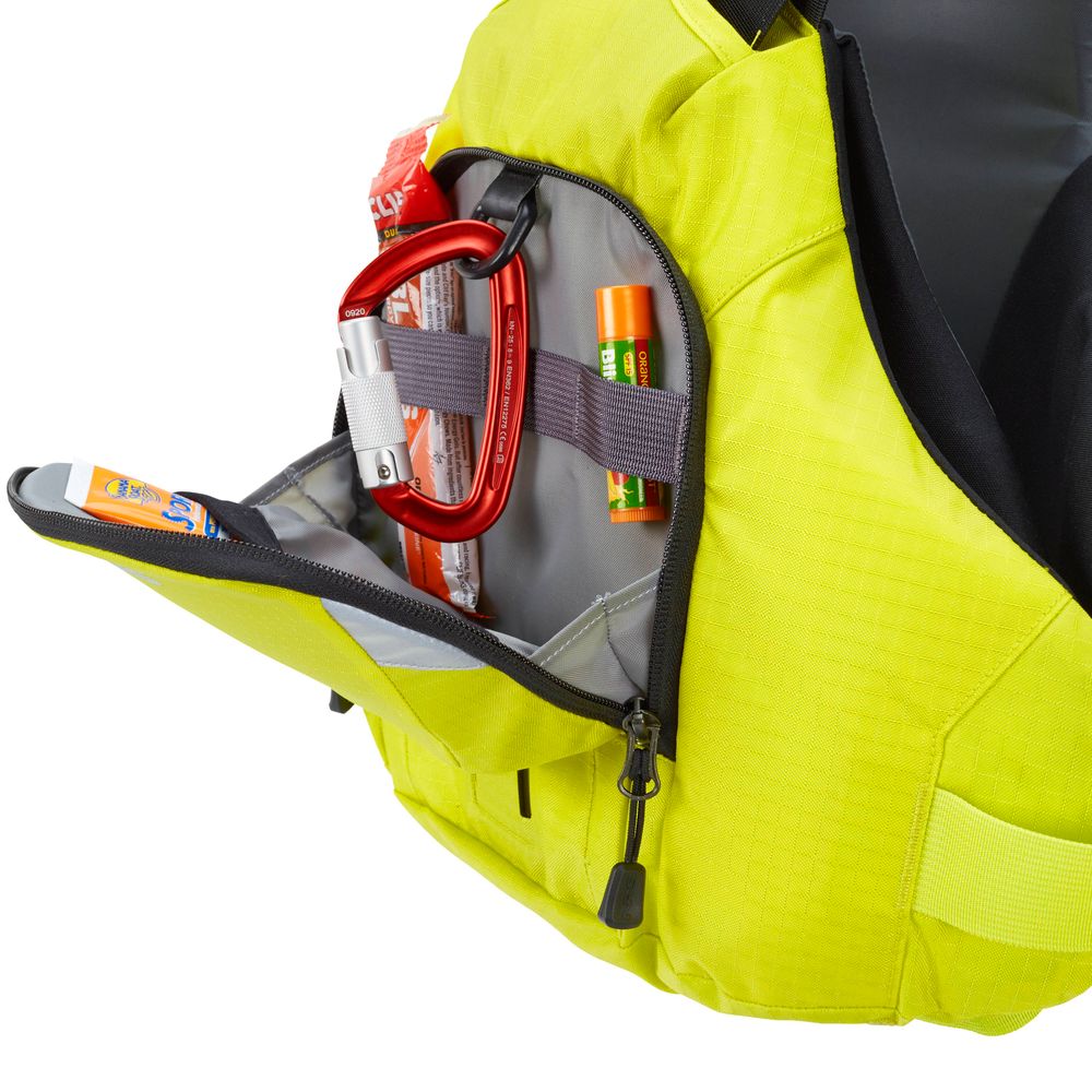 The NRS Ninja PFD's yellow bag pocket unzipped, revealing a red carabiner and lip balm inside, essentials for any adventure.