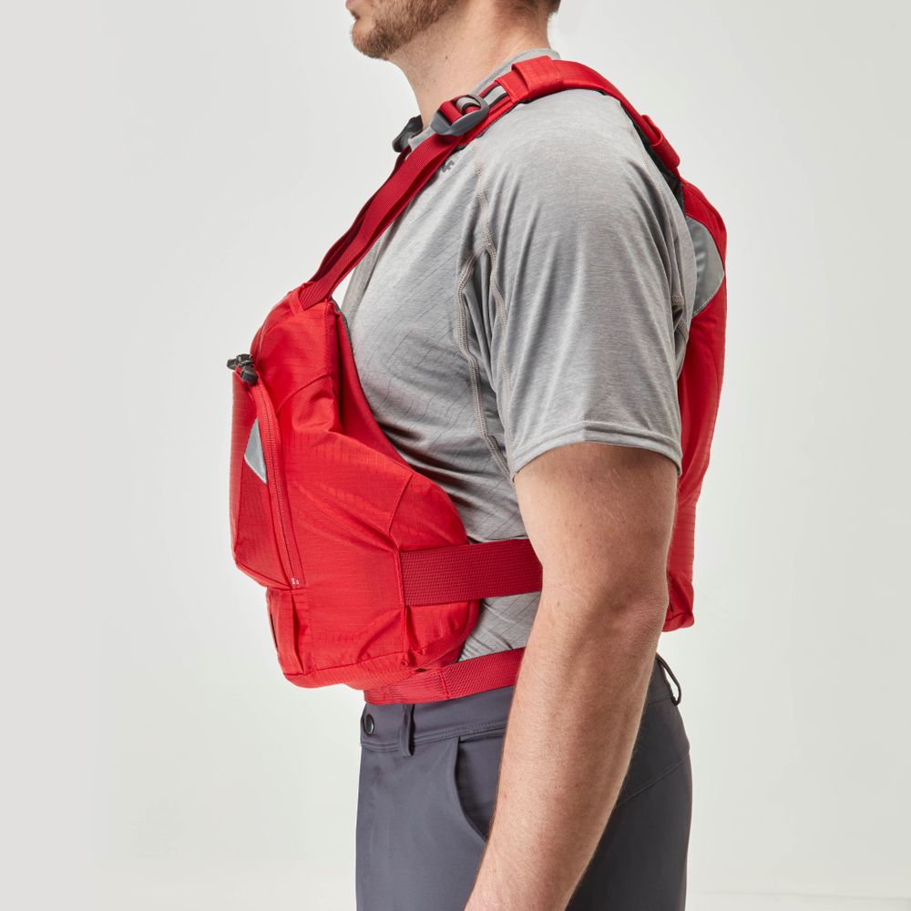 Wearing a gray shirt and dark pants, the person showcases the NRS Ninja PFD, known for its compact flotation, against a light background—exemplifying style and functionality for paddlers.
