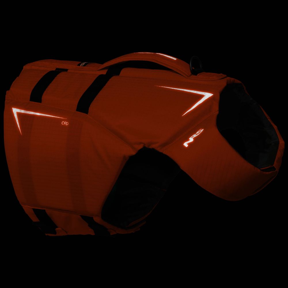 The NRS CFD Dog Life Jacket features red fabric, black straps, and reflective accents—combining safety and style for your dog against a sleek black background.