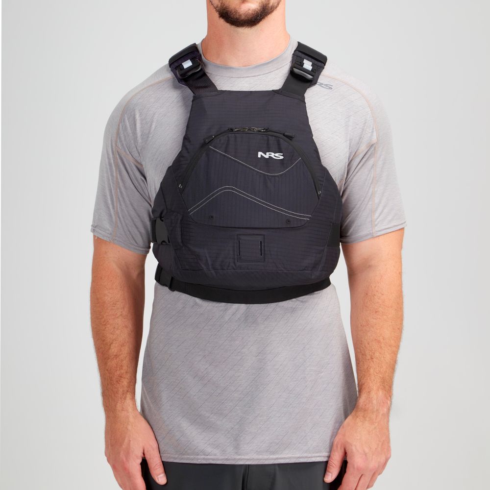 Wearing a gray shirt, a person sports the NRS Ion PFD—a black life jacket featuring adjustable straps, pockets, and ultra-soft foam. This Type III PFD is designed with a Cool Flow System for enhanced comfort.