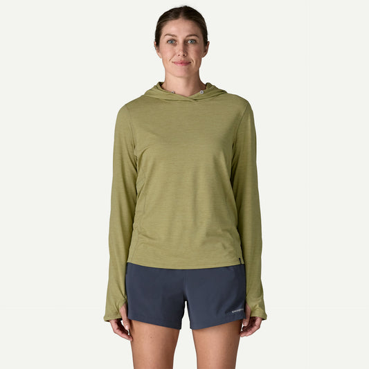 A person wearing a light green Patagonia Cap Cool Sun Hoody W's and dark gray shorts stands facing forward against a plain light background.