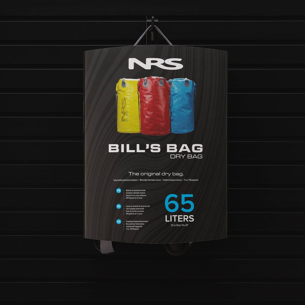 Advertisement for NRS Bill's Bag, presenting three vibrant dry bags in yellow, blue, and red. Each bag includes backpack straps for easy carrying and compression straps for space optimization, with a 65-liter capacity and durable material to keep gear dry on any adventure.