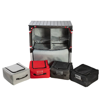 The Camp Chef Sherpa Table & Organizer is a portable camping storage unit with a foldable tabletop, zippered shelves, and four removable storage bags in gray, red, and black—an ideal table for your next outdoor adventure.