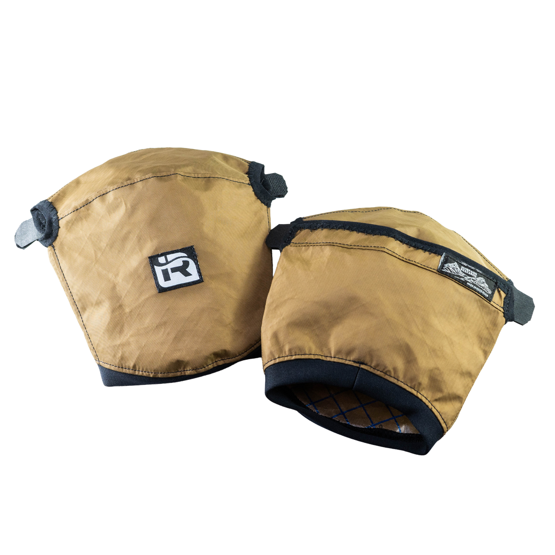 The Immersion Research Nanowave Handwarmer Pogies are lightweight, brown handwarmers with black trim and Velcro straps, designed for warmth and comfort, featuring small brand logos on the front.