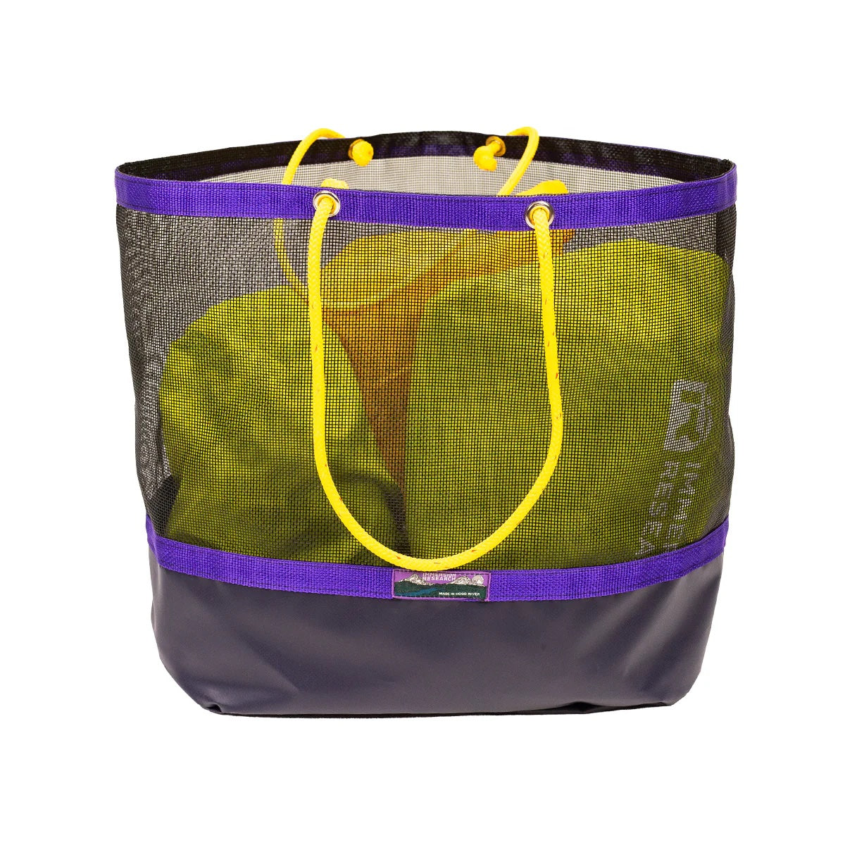 The Haulin Toats mesh tote by Immersion Research features purple trim and yellow rope handles, and includes a folded green item inside.