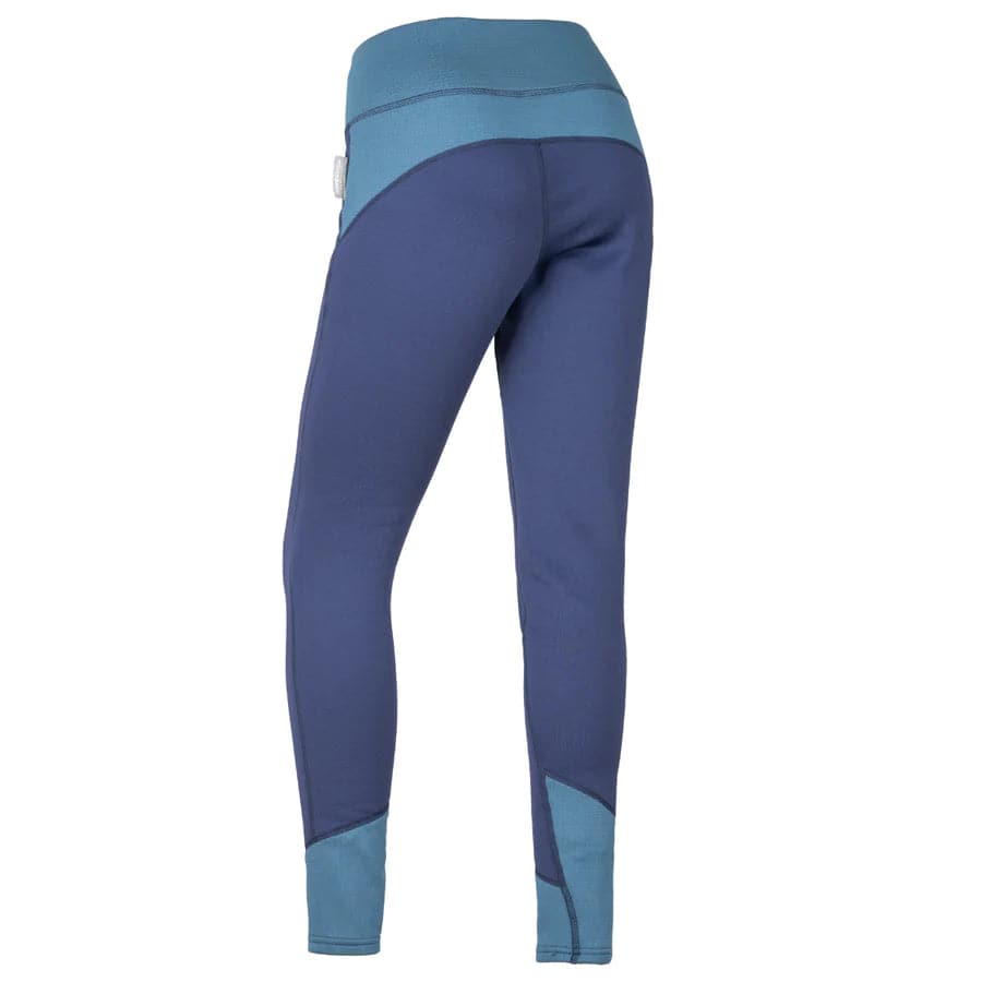 The back view of a woman's blue Immersion Research Susitna Pants in a performance fit.
