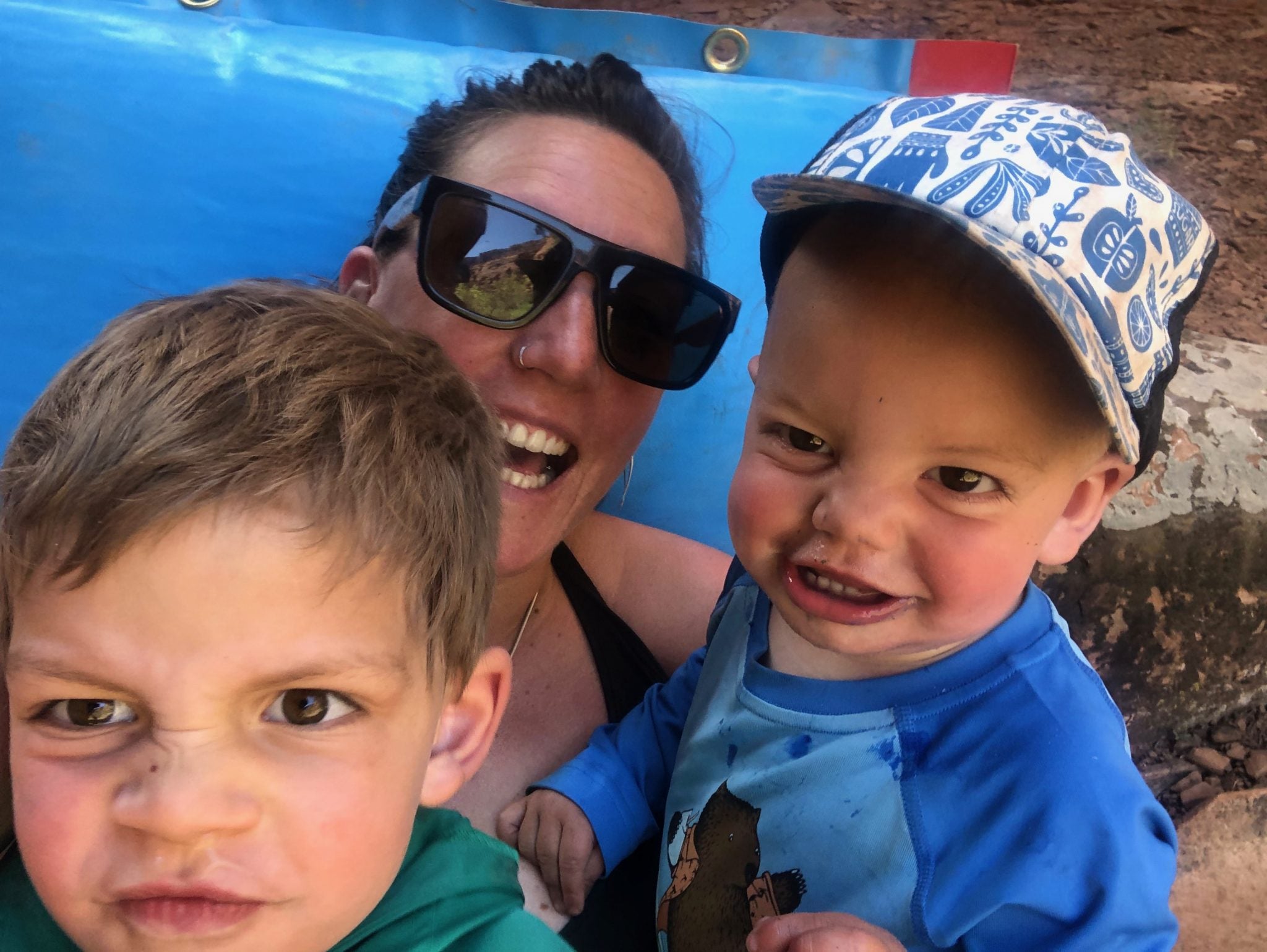 a woman and two boys posing for a picture.