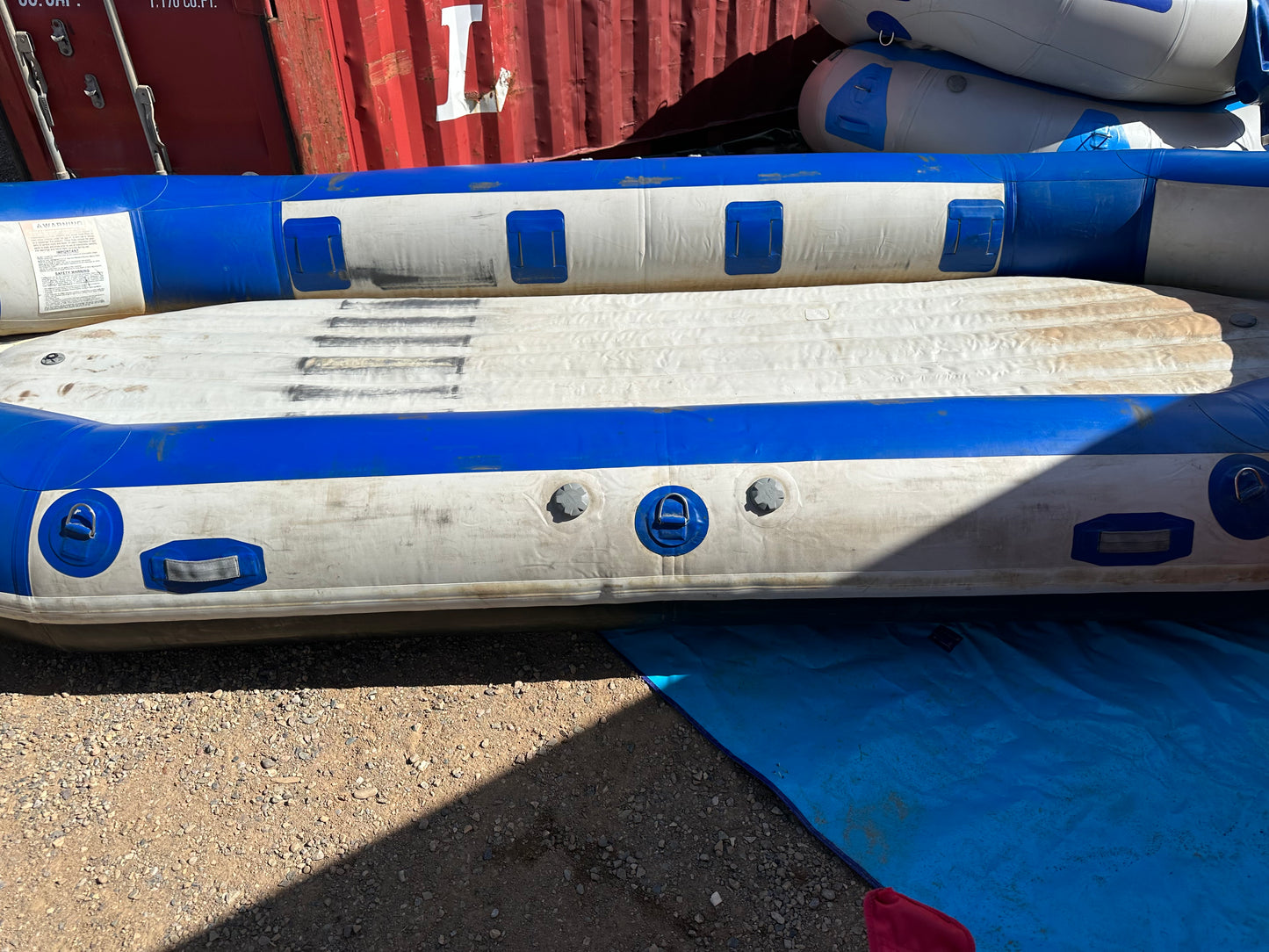 A Used 16' Vanguard Raft in fair condition is sitting on the ground, branded by 4Corners Riversports.