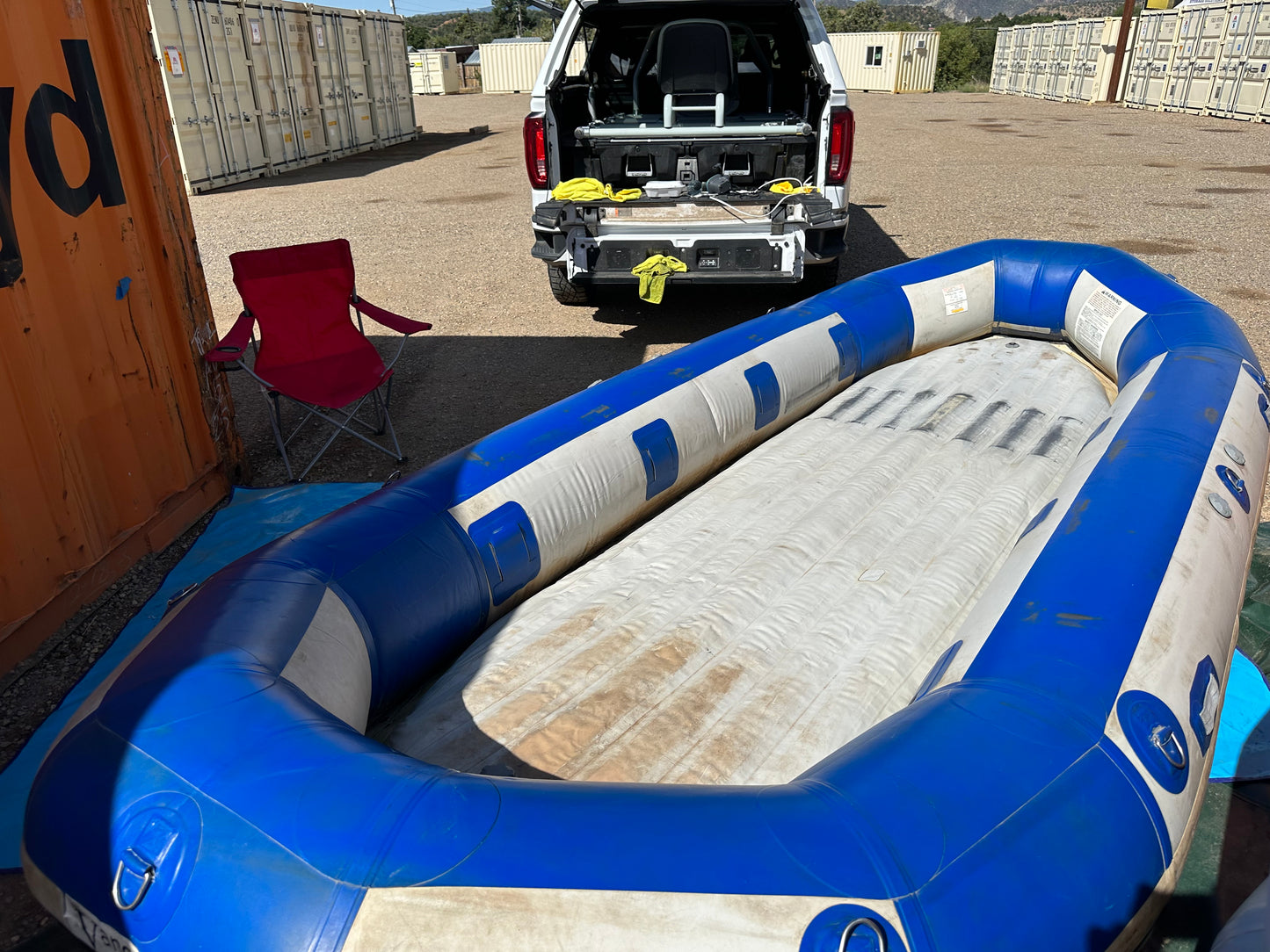 A used blue and white 16' Vanguard Raft inflatable boat in fair condition, maintained by 4Corners Riversports.