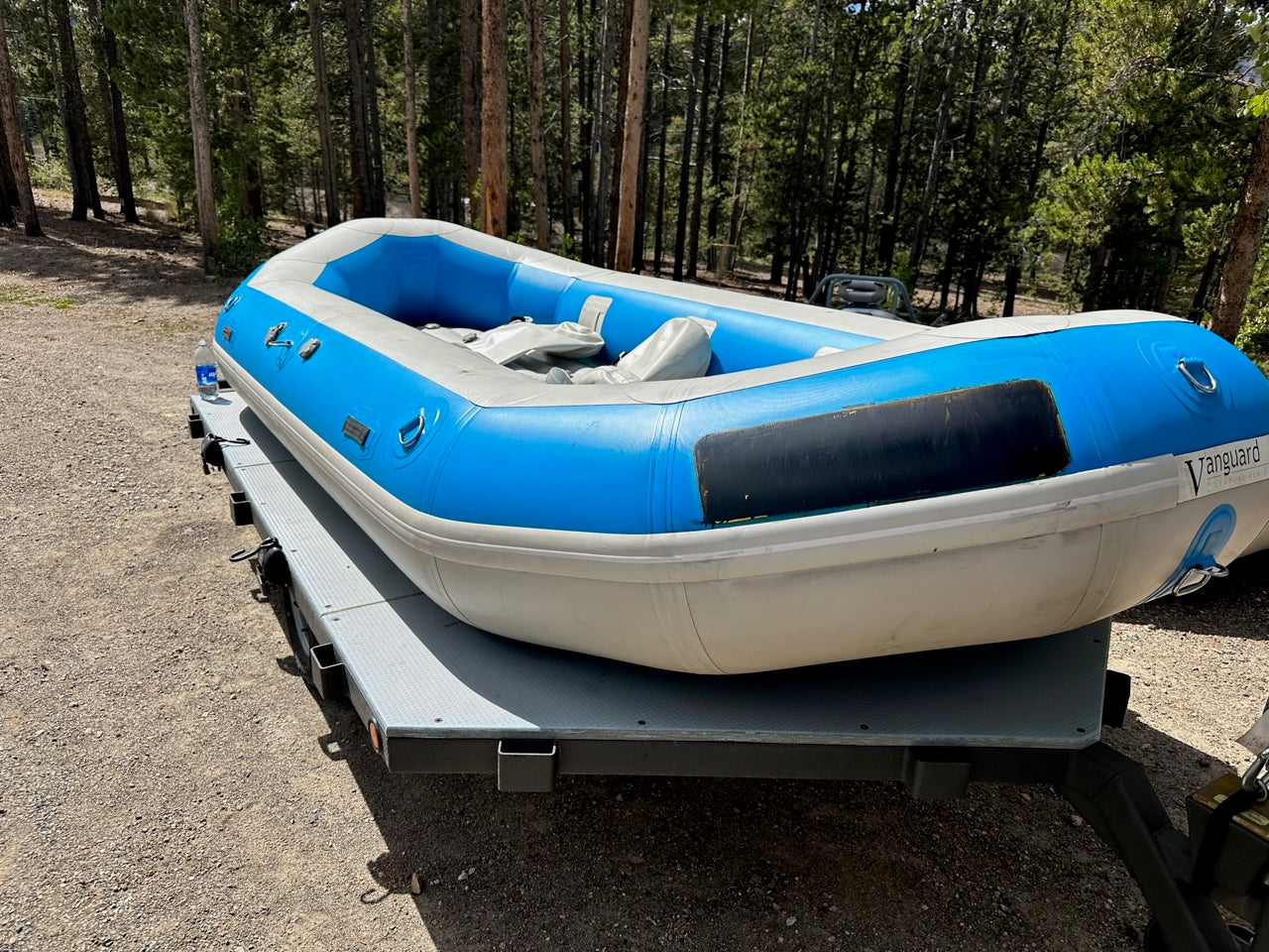 A lightly used 14' Vanguard raft in good condition on the back of a trailer from 4Corners Riversports.