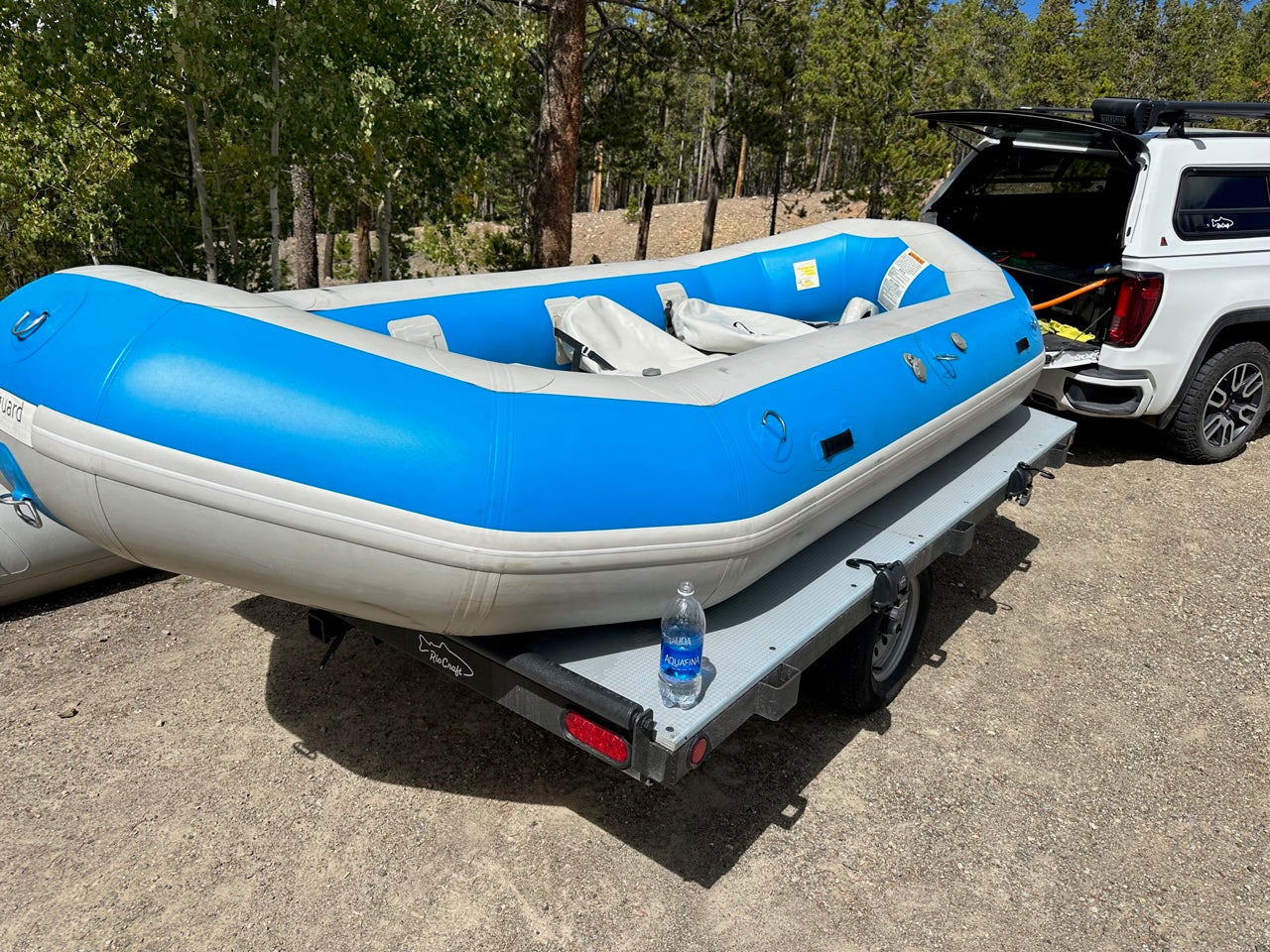 A lightly used 14' Vanguard Raft in good condition, secured on the back of a truck, from 4Corners Riversports.