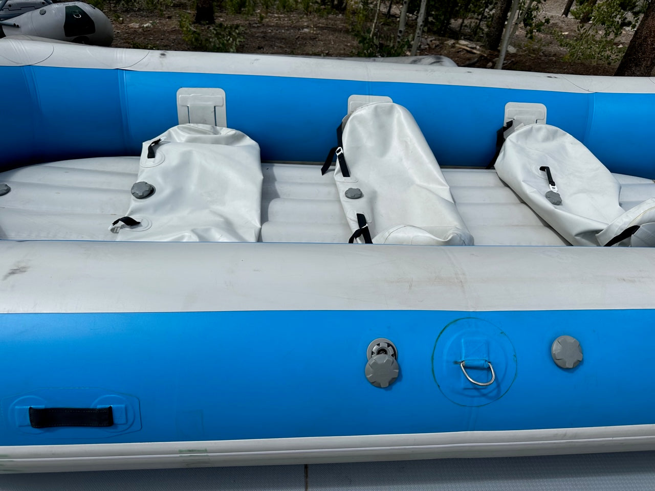A lightly used blue and white Used 14' Vanguard Raft with four seats, in good condition from 4Corners Riversports.