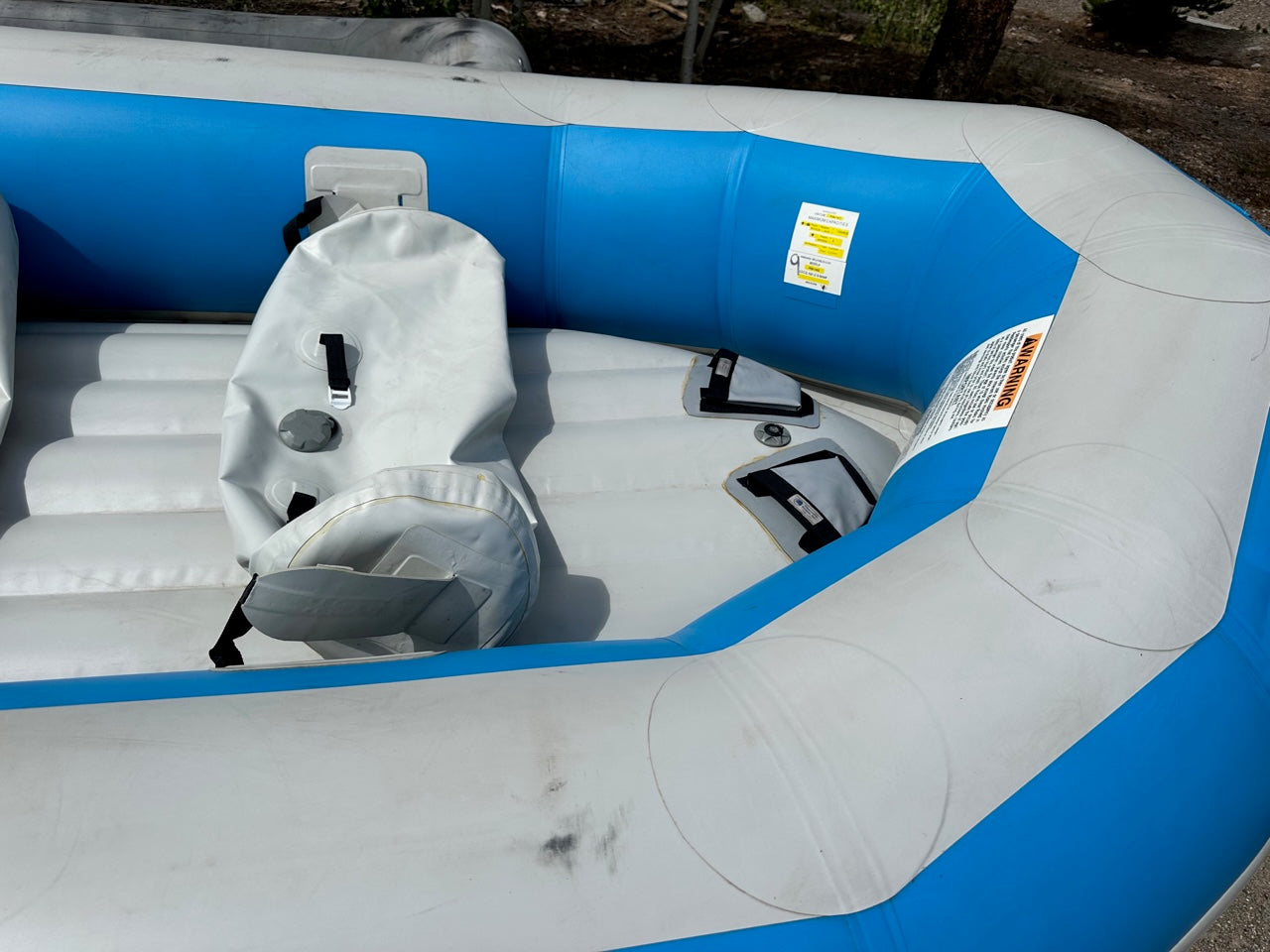 A lightly used 14' Vanguard Raft by 4Corners Riversports in good condition - a blue and white raft with an inflatable seat.
