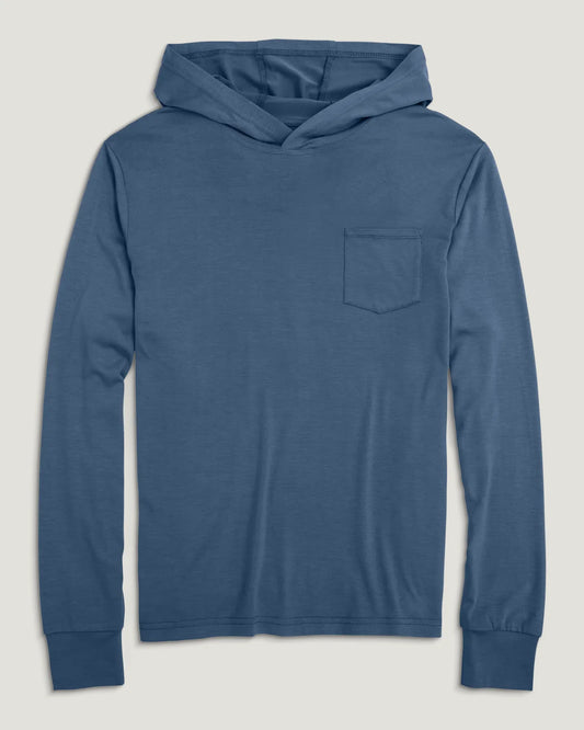 The Free Fly Youth Bamboo Shade Hoody, shown here in blue with long sleeves and a chest pocket, delivers UPF 50+ sun protection—perfect for kids’ outdoor activities.