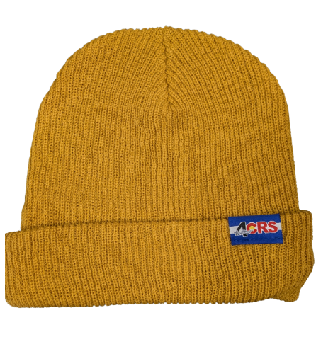 The Captuer Headwear 4CRS Super Slouch Beanie in mustard yellow features a folded brim and a rectangular patch with "4CRS" in blue, red, and white—a stylish pick for your next trip to the paddle shop.