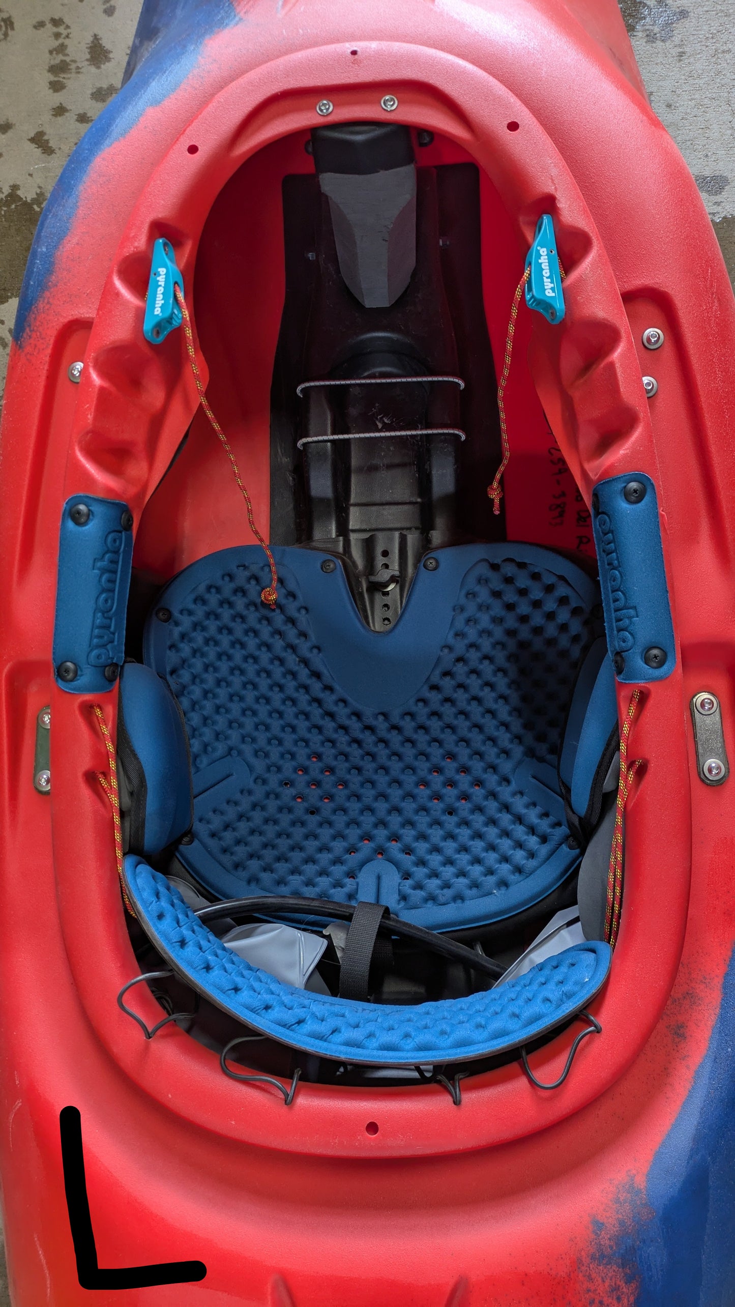 Top view of the Pyranha Demo Helectron kayak cockpit, highlighting the seat, padding, footrests, and safety straps—a great choice for anyone seeking a reliable used kayak from our demo fleet.