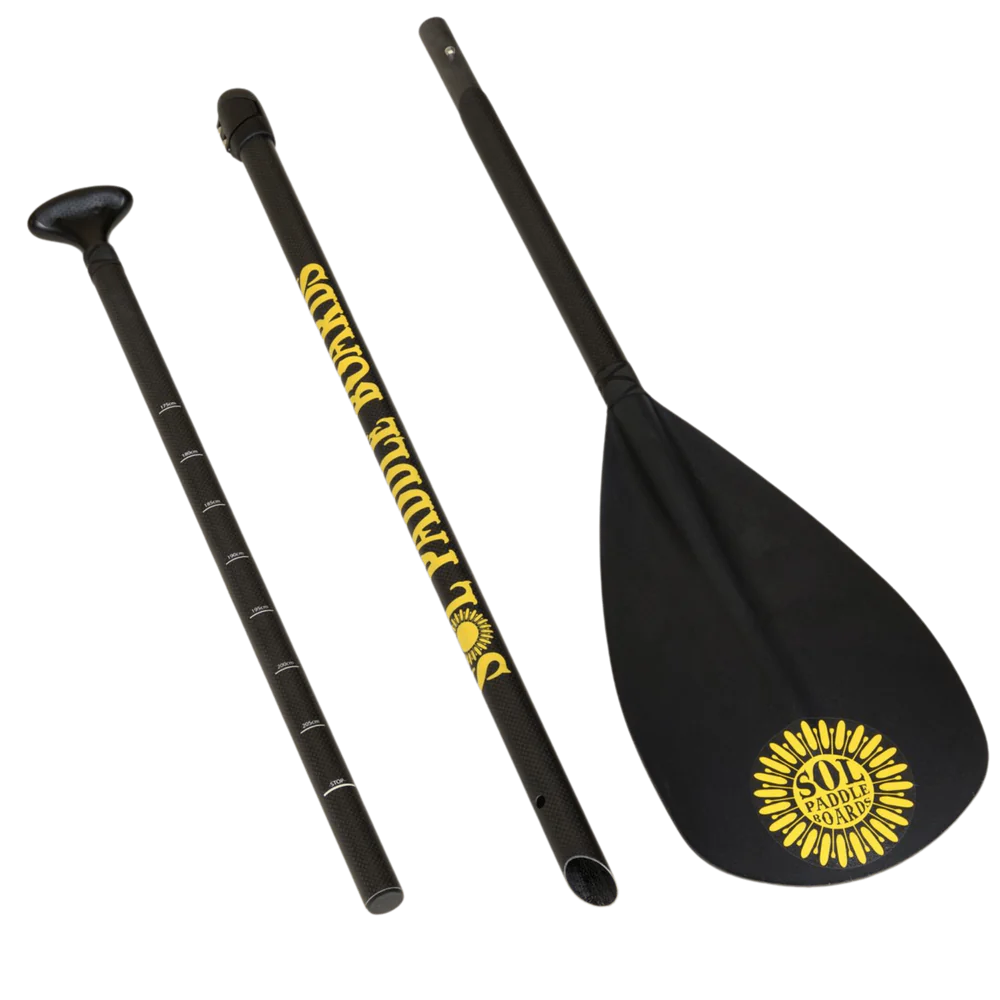 A three-piece SUP paddle with a carbon shaft and yellow sunburst blade logo, branded by SOL Paddle Boards as the Carbon Blaster 3-Piece Travel.