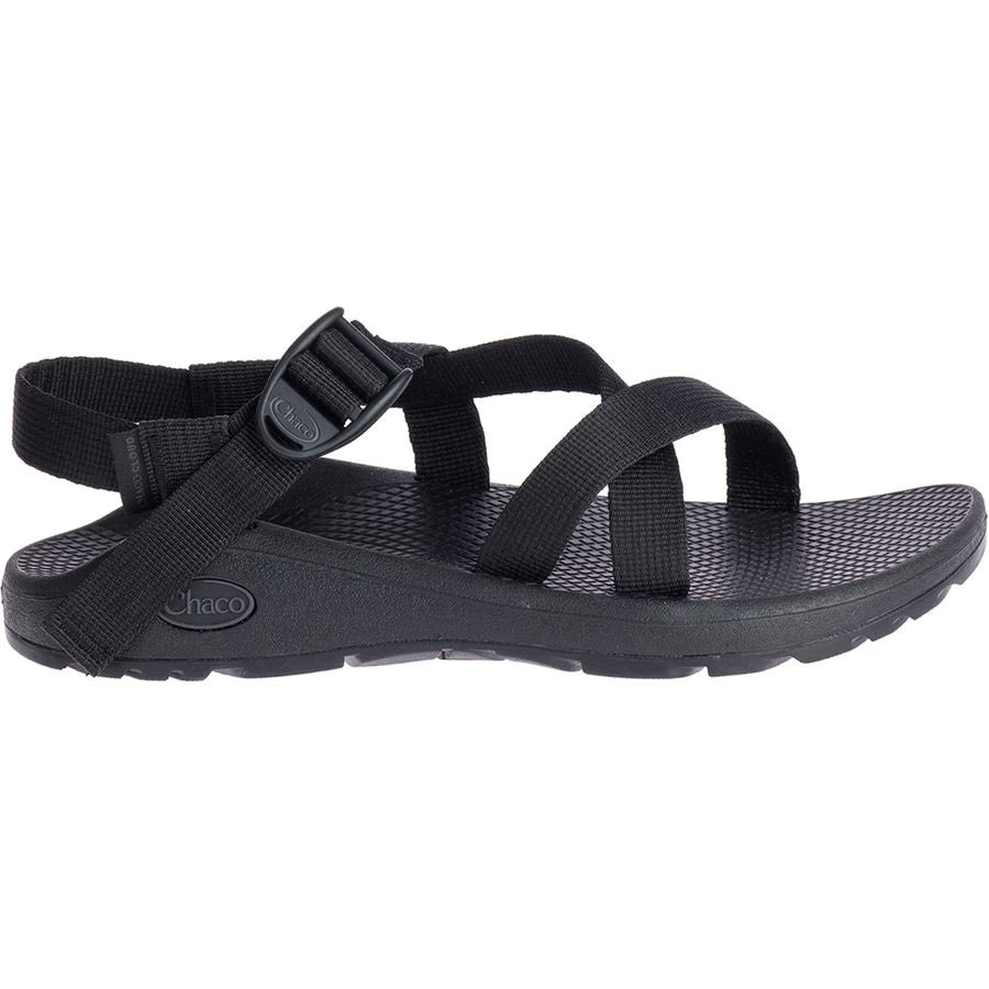 A side profile of a single black Chaco ZCloud - Women's sandal with adjustable straps and a textured sole, featuring Cloud Cushioning, shown against a white background.