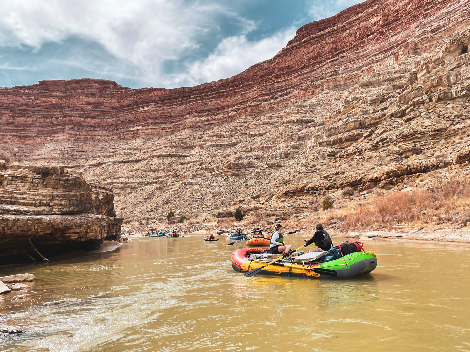 a group of people on a raft in a river.