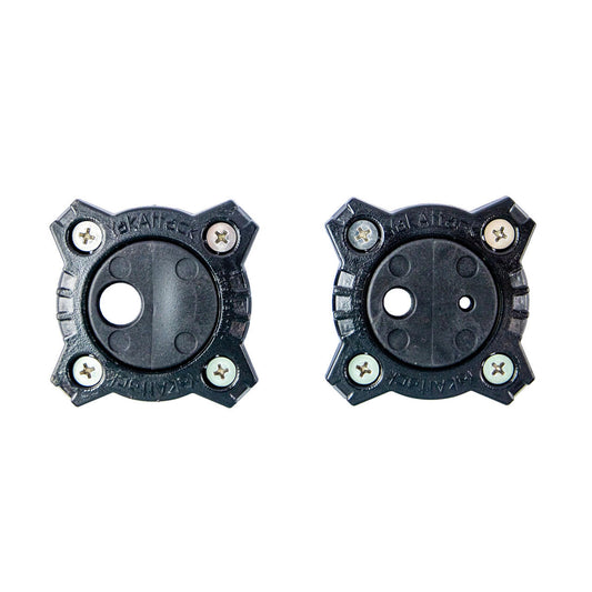 Two black plastic GridLoc Through Hull Wiring Kit mounts by YakAttack, each with four screws and unique central holes, are shown side by side on a white background for BlackPak Pro or GridLoc Wiring Kit installation.