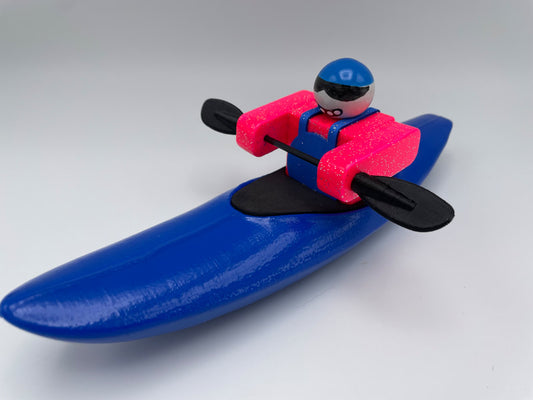 Toy whitewater kayaker made by Foamie Friends. Blue kayak, pink body, blue pfd. River Play toy