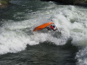 a man riding a wave on top of a surfboard.