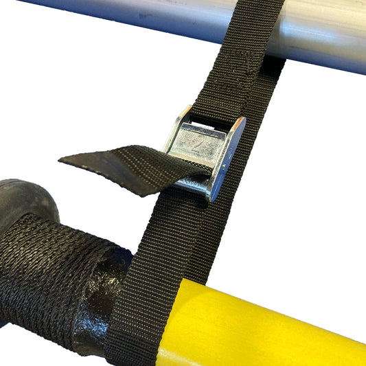 A Coyote River Gear Spare Oar Keeper features a black cam strap with a metal buckle, securing two poles—one gray and one yellow.