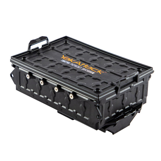 The YakAttack TracPak with PicPocket QuickDraw is a black rectangular storage box with a textured lid, raised logo, and latch closures, ideal for outdoor or kayak use.