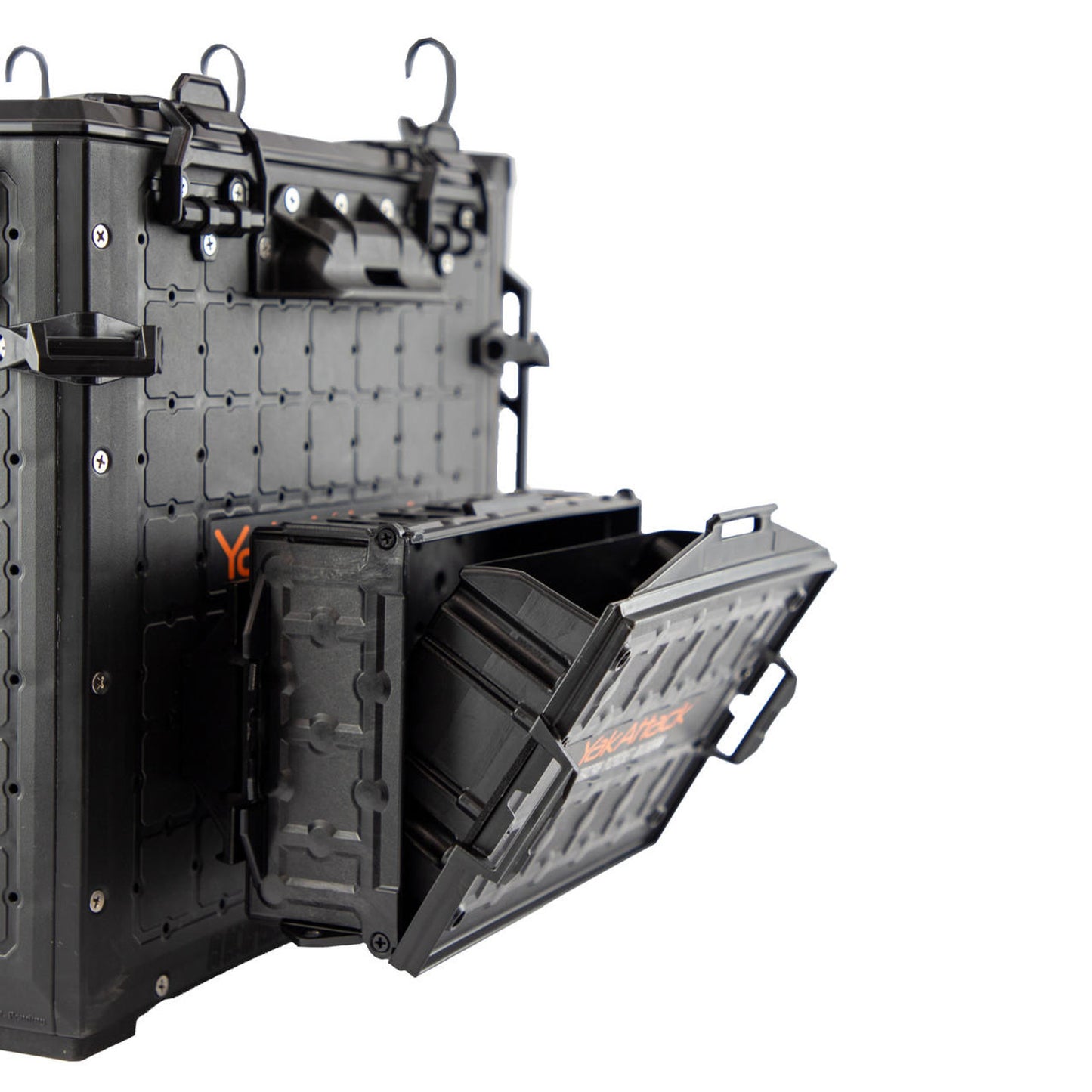A YakAttack TracPak with PicPocket QuickDraw in black is wall-mounted, shown with its box open to reveal the hinged lid and interior compartment.