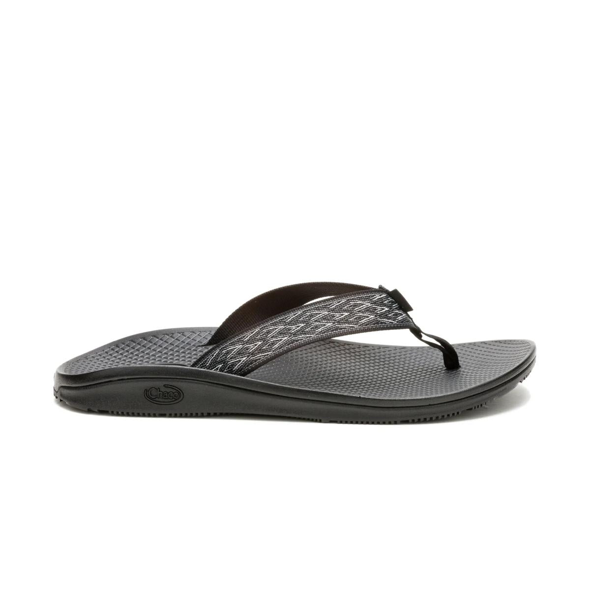 The Chaco Classic Flip - Men's is a black flip flop sandal with a textured sole and patterned fabric strap, shown on a white background—ideal for anyone wanting vegan-friendly footwear.