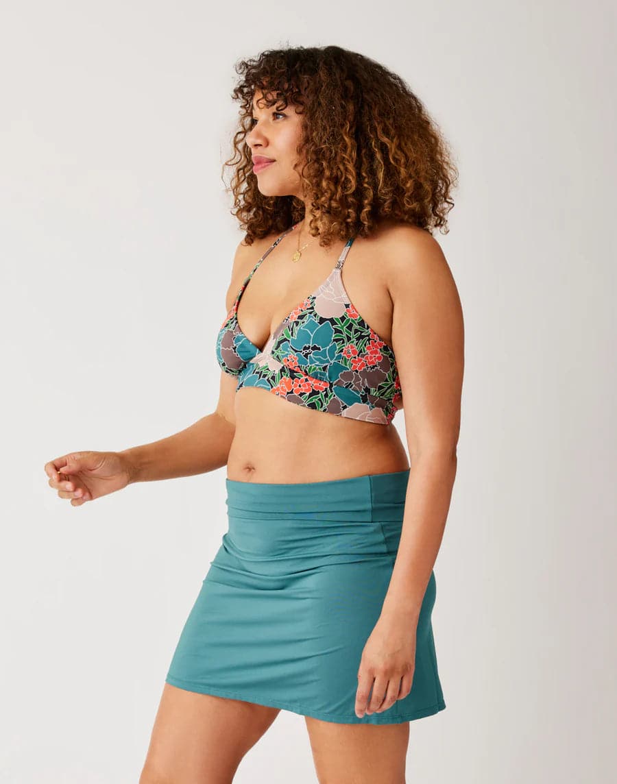 A woman in a Carve Dahlia top and skirt.