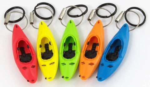 The Whitewater Keyak Key Chain from Kingdom Outdoor Products features five vibrant colors—red, yellow, green, orange, and blue—each boasting black seating details and finished with sturdy metal rings.