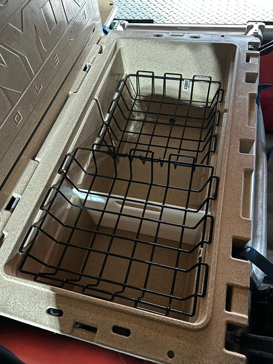 Open Prospector 103 Divider by Canyon Coolers in beige, featuring a BPA-free black wire basket inside, resting on a textured surface.